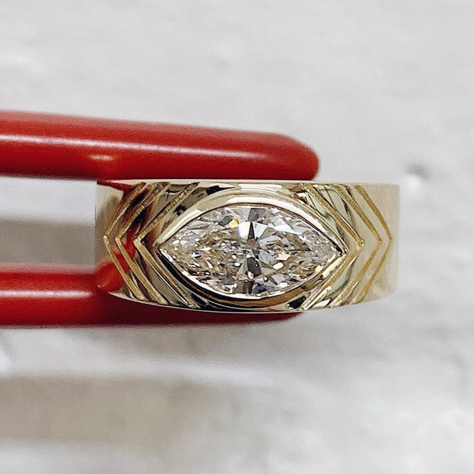 custom wide band ring with burnish set baguette