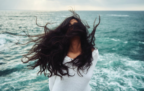 woman standing in front of the ocean