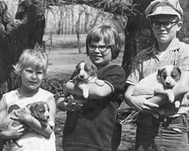 An early photograph of mine of some farm kids and their new puppies.