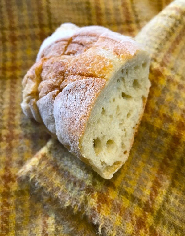 A hunk of bread. When wadded up, the soft center may have been used as an eraser. The whole hunk could be used to absorb excess paint.