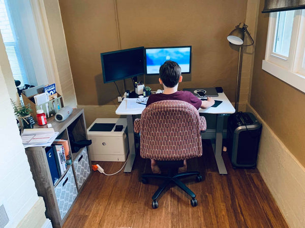 Child sitting in front of Sit to Stand Desk