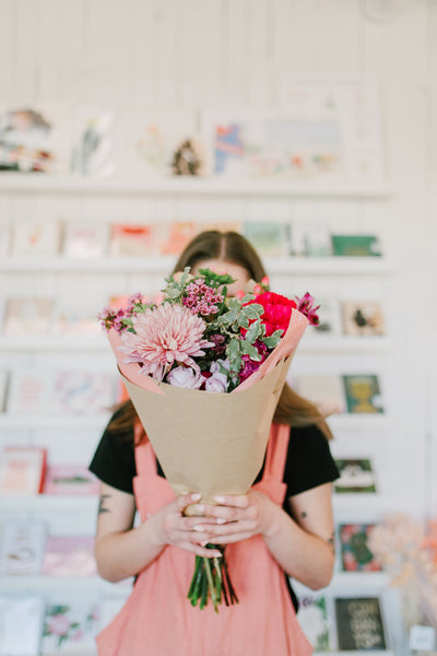 Native Poppy florist holding flower bouquet