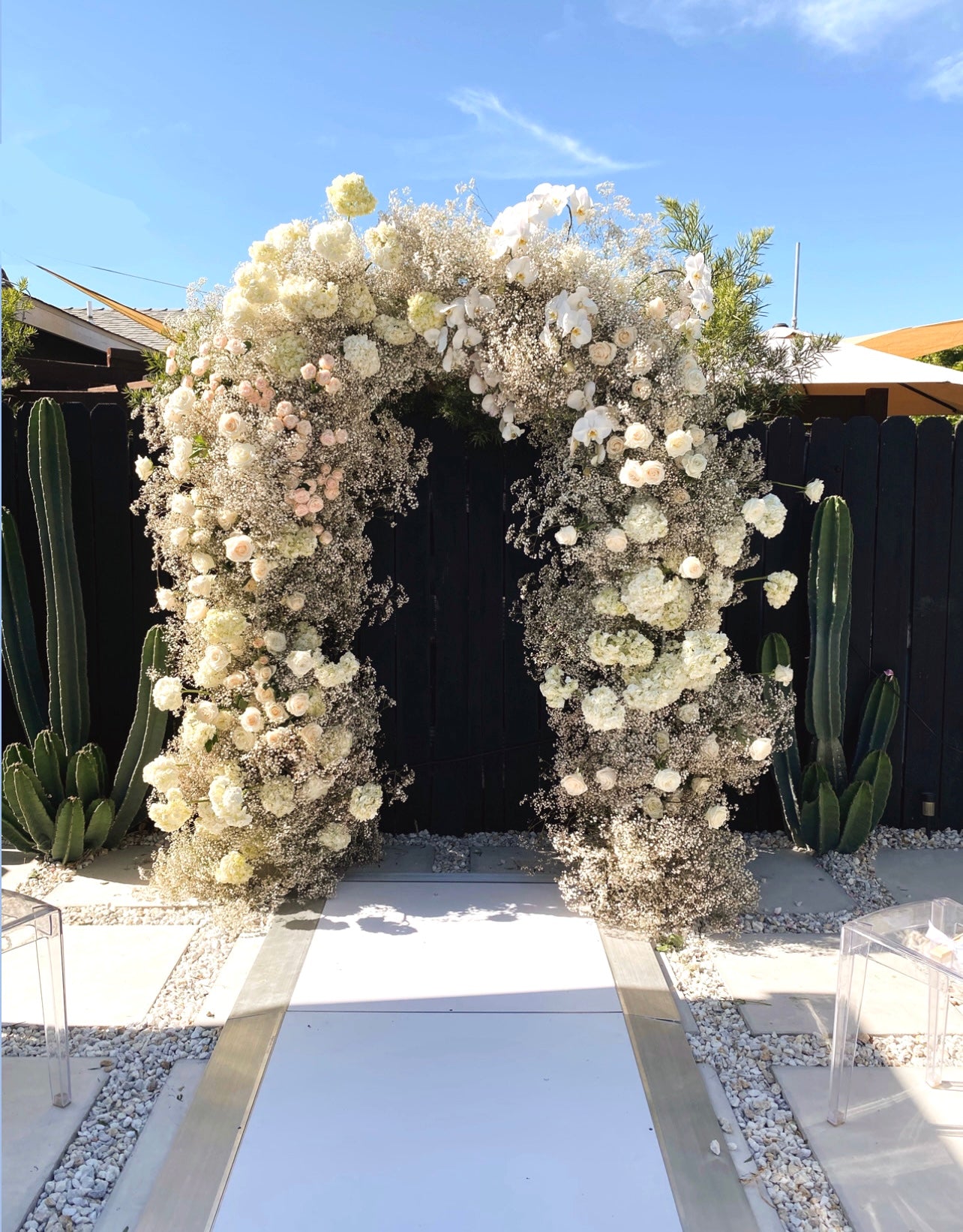 White baby's breath and rose floral arch.