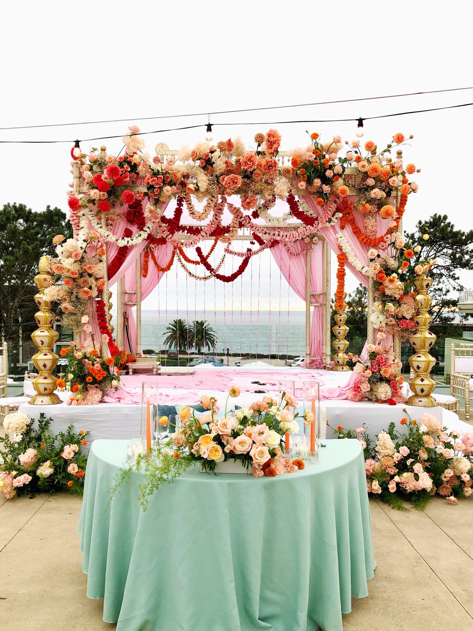 Traditional hindu four tiered floral arch.