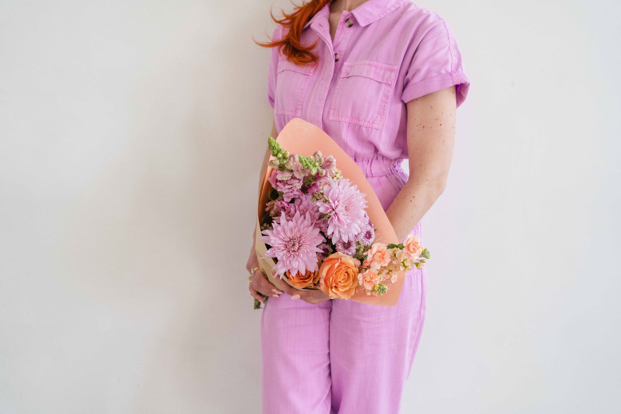 Mum-Believable flower wrap held by florist in jumpsuit