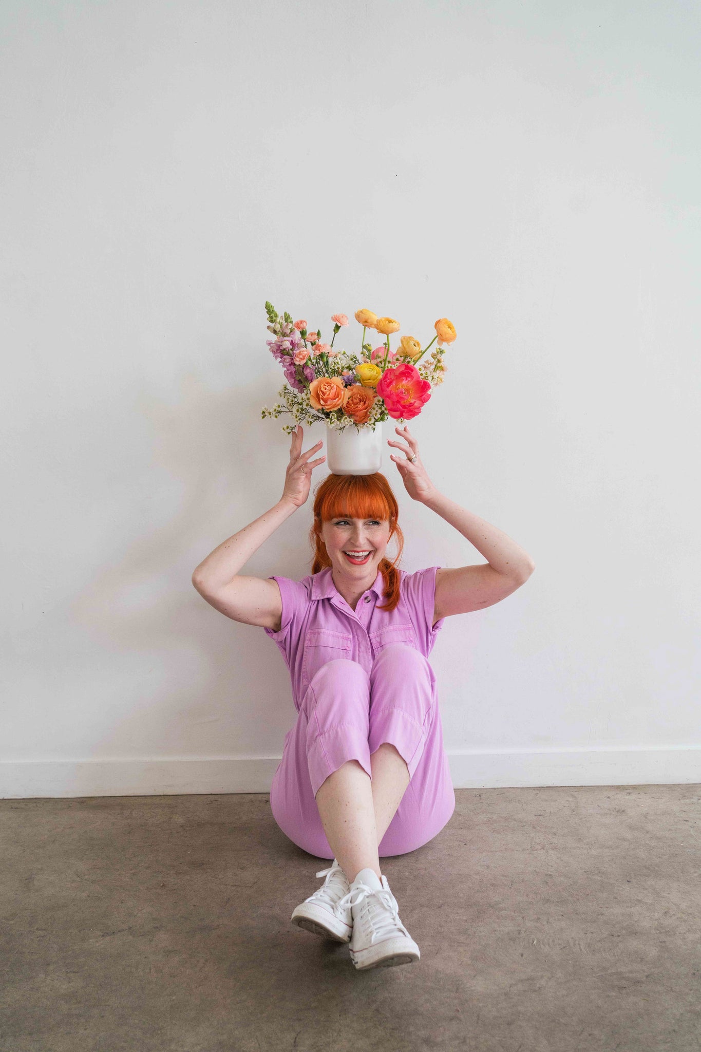 Florist balancing a Mother’s Day flower arrangement on her head