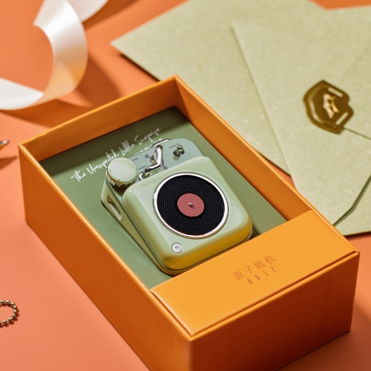 Mint green mini wireless speaker in an orange box