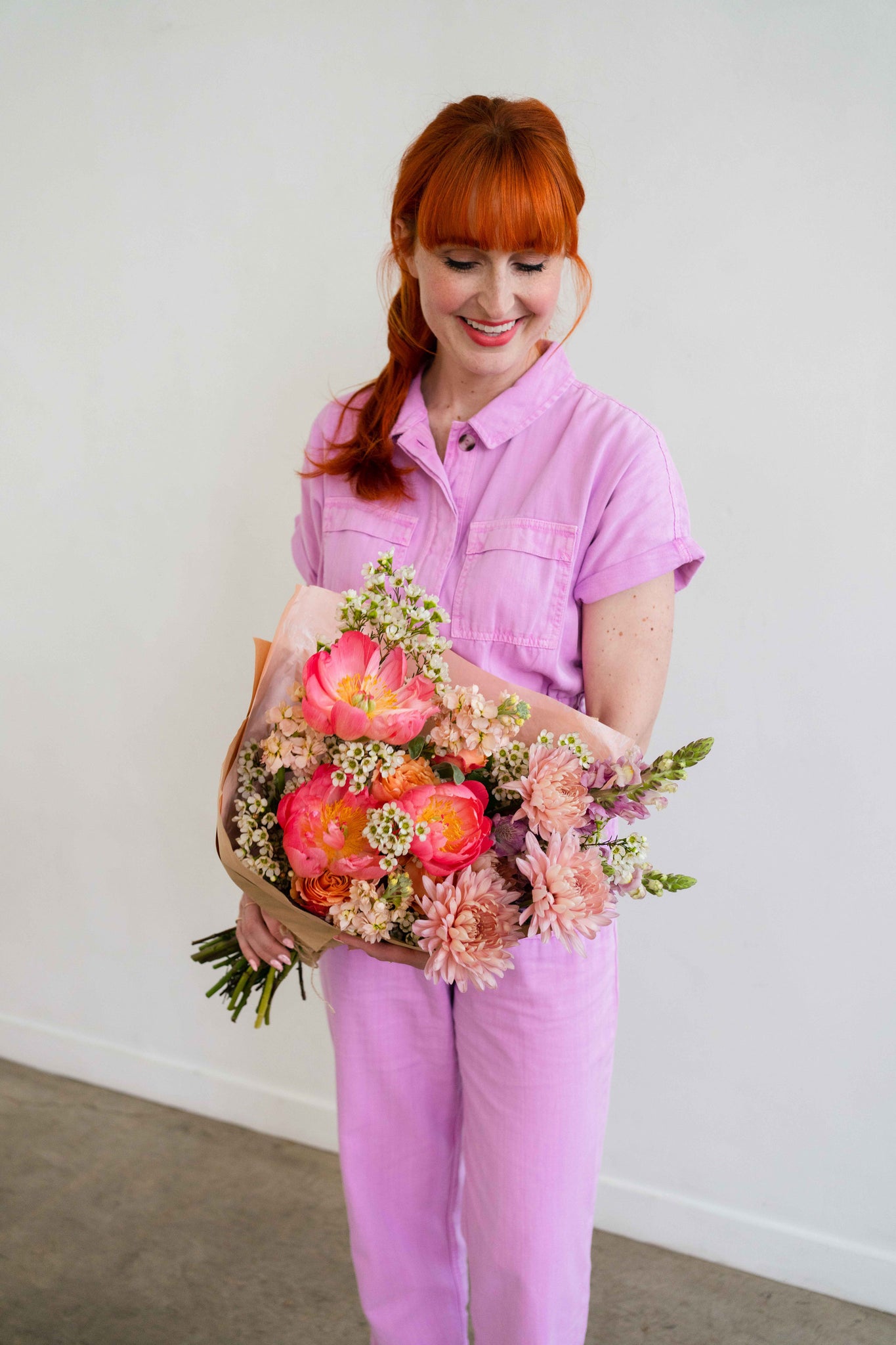 Florist holding Mother’s Day flowers with peonies