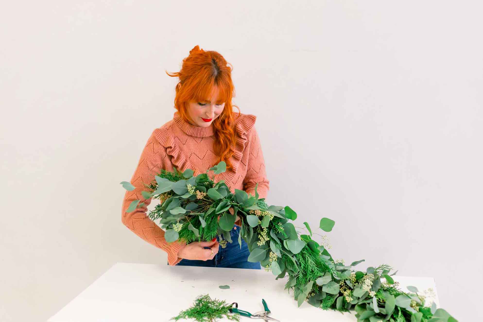 Meg Blancato builds greenery garland for Native Poppy