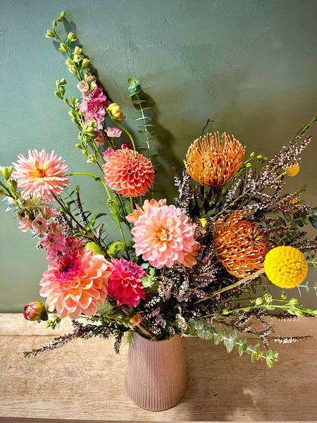 Fresh flowers in a textured tall vase