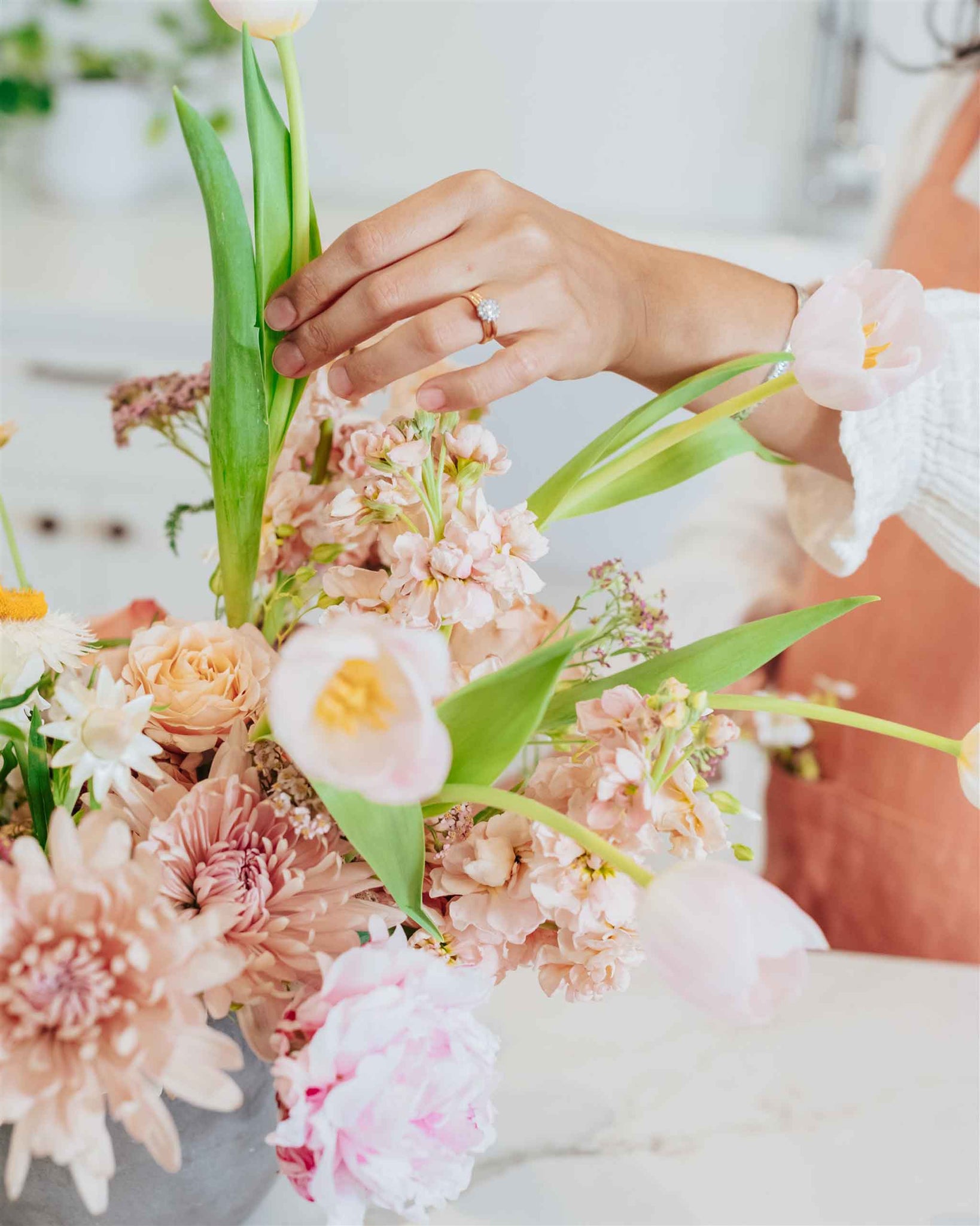 Woman's hand arranging beautiful flowers