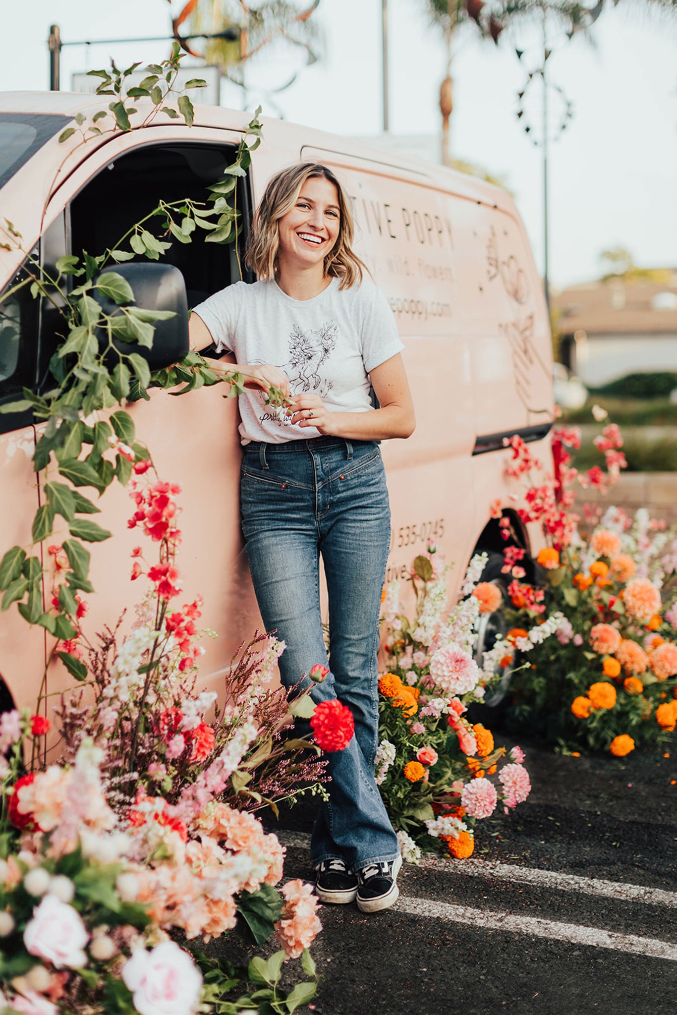 Natalie Gill standing in front of Native Poppy's flower delivery van