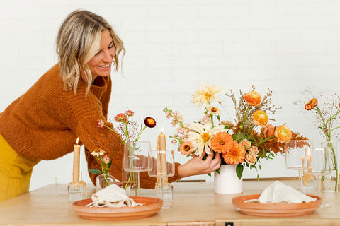 Natalie Gill adding flowers to Thanksgiving table