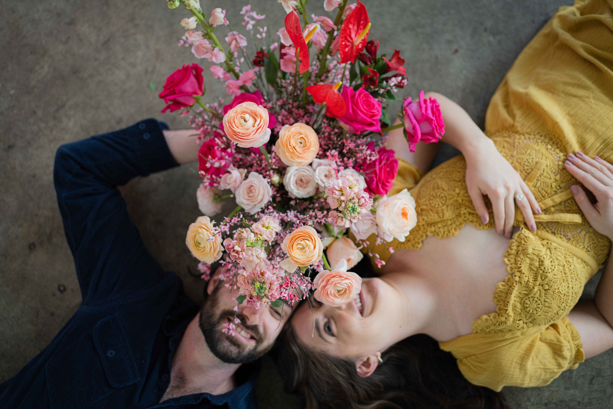 Couple laying with valentine arrangement