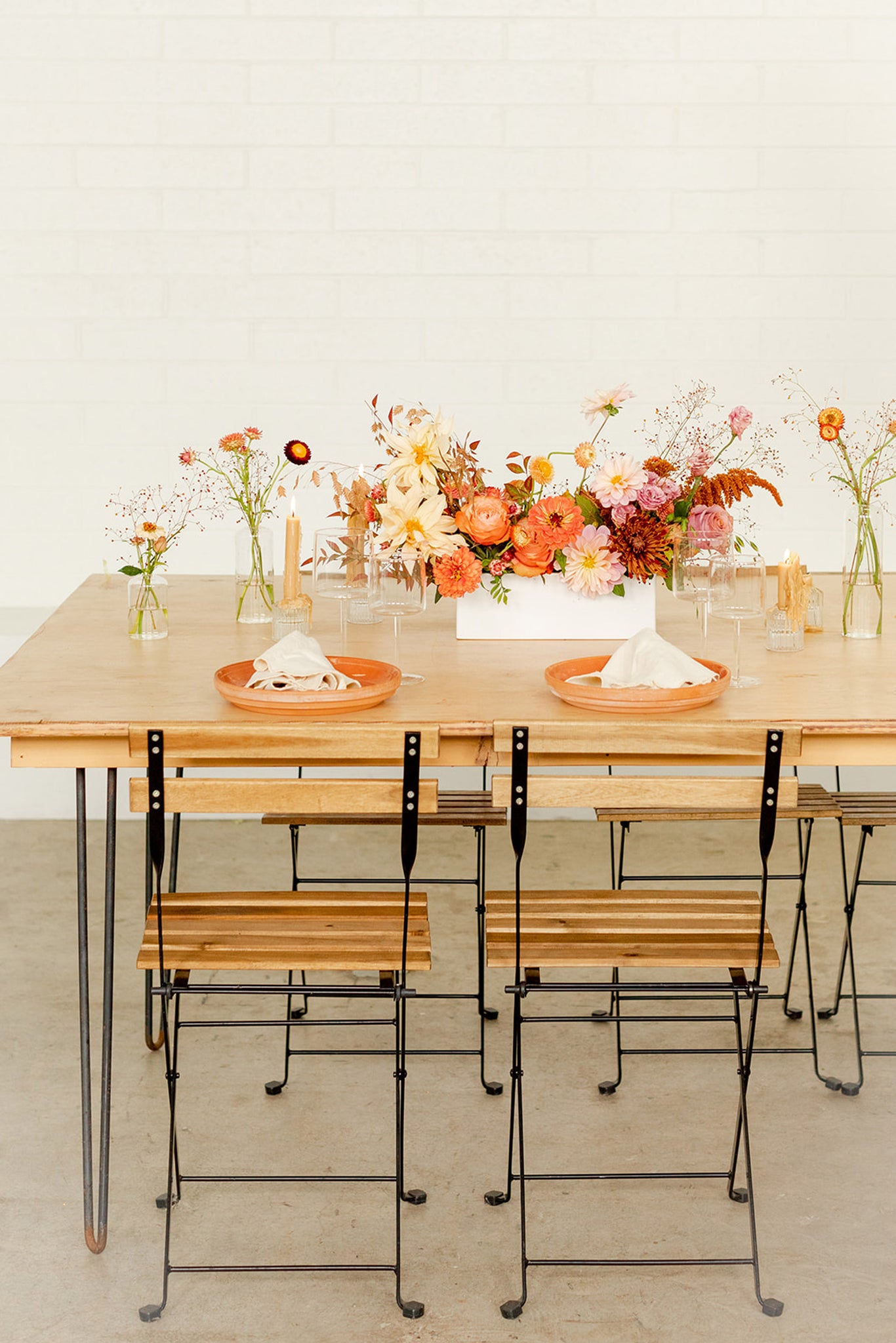 Thanksgiving table with flowers and plates and chairs