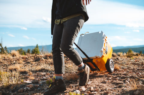 Woman pulls RollR 45 across campsite.