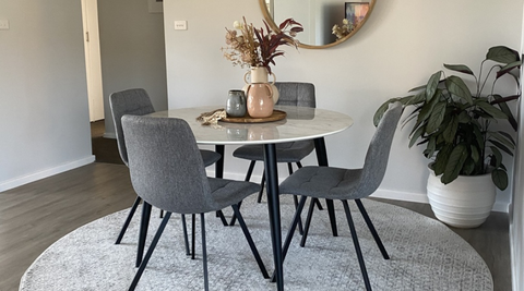 Round rug under a dining table