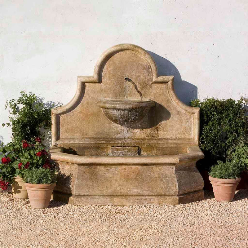Campania International Andalusia Wall Fountain is made of cast stone and stained in the Aged Limestone Patina.