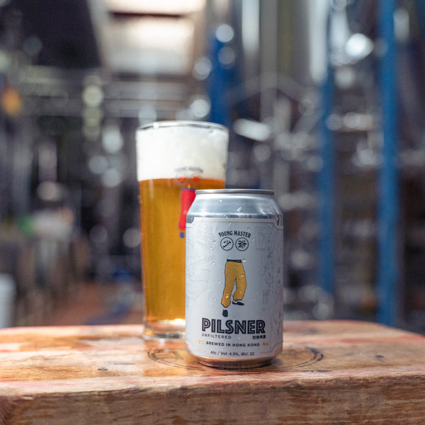 A can of Young Master Unfiltered Pilsner next to a glass