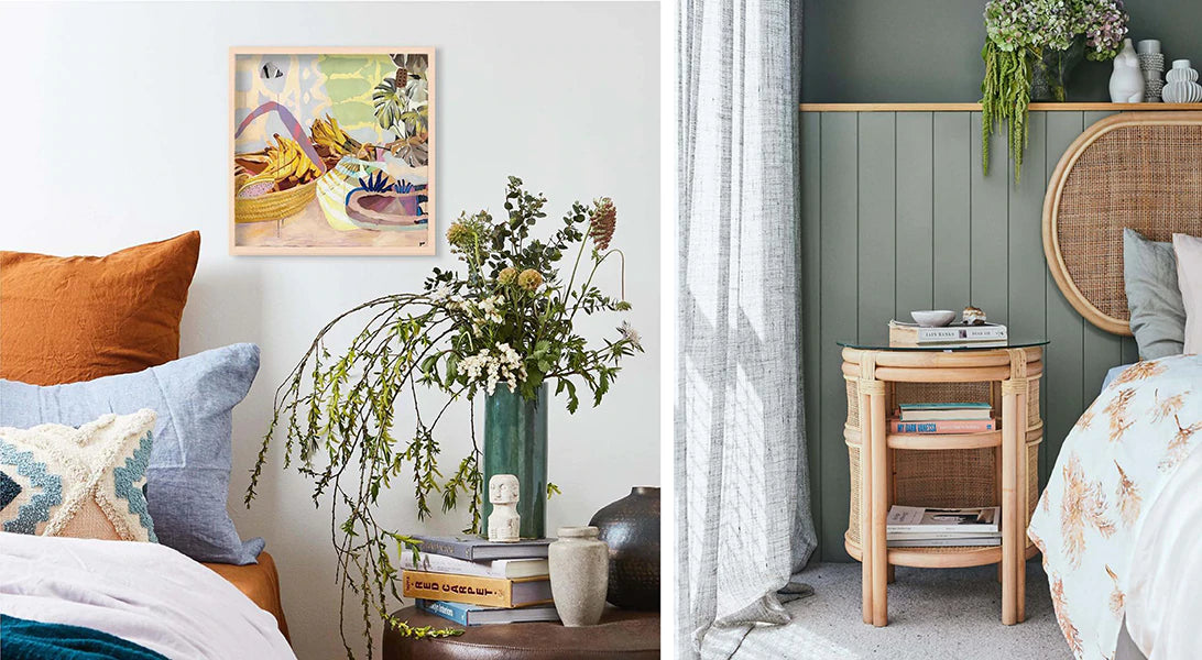 Bedside table with coastal style decor, terracotta colour bed linen, sage walls, rattan and cane furniture, earth tone artwork, vase filled with Australian natives and plants.