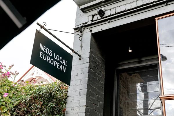 Signage of Ned's Bake Local European with downlight at entrance