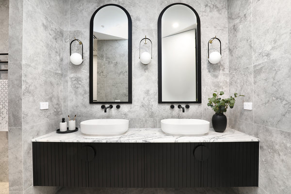 white bathroom with lighting on the wall