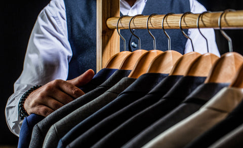 Wooden hangers holding garments