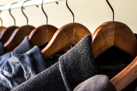 Winter clothes on wooden hangers