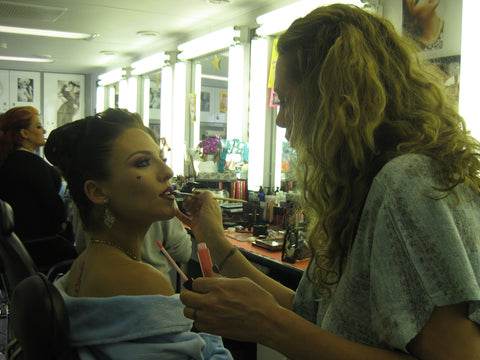 Makeup artist applying lips