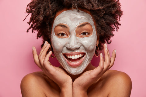 black woman with clay face mask