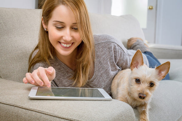 Woman using pad with her puppy