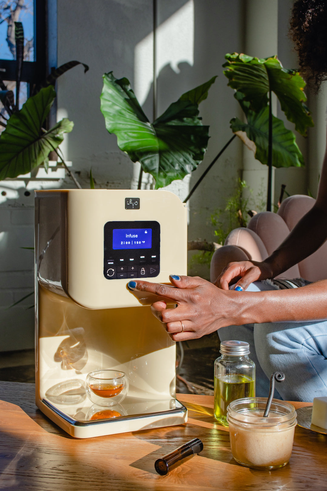 Image of the LĒVO II herbal infusion device being used to make herb oil.