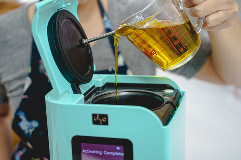 pouring olive oil into LĒVO II machine