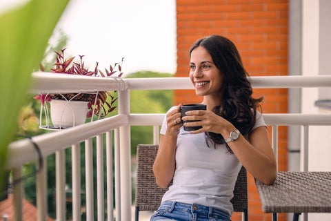 woman drinking elderberry infused honey in tea