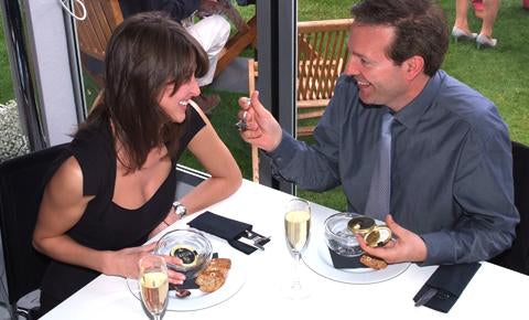 a couple enjoying caviar and discussing about the taste