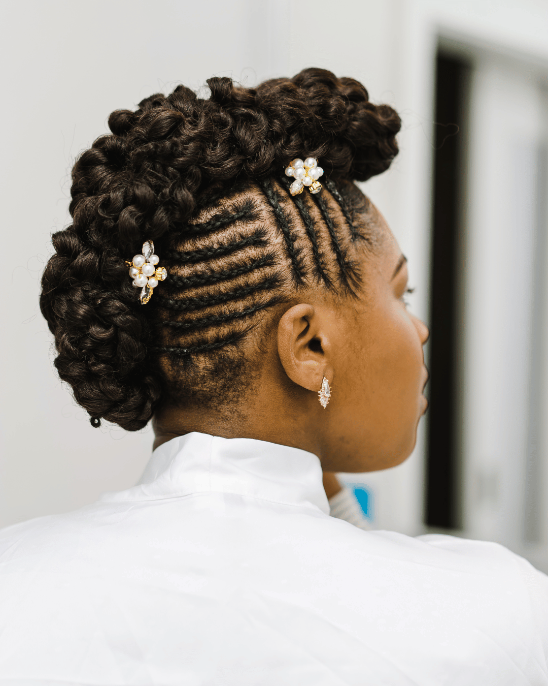 Embellished braids with diamond pins and pearl clusters for fairy tale-inspired bridal look.