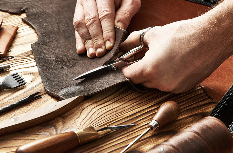 Cutting leather to make the wallets