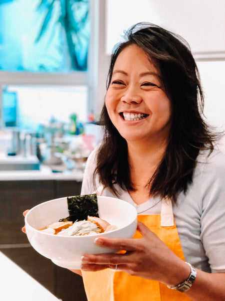 Nona Lim holding the Spicy Chicken Miso Ramen Noodles from the Noodle Night Kit.