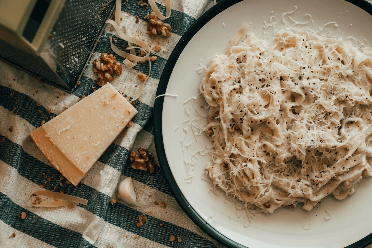 spaghetti carbonara with parmesan on blue blanket