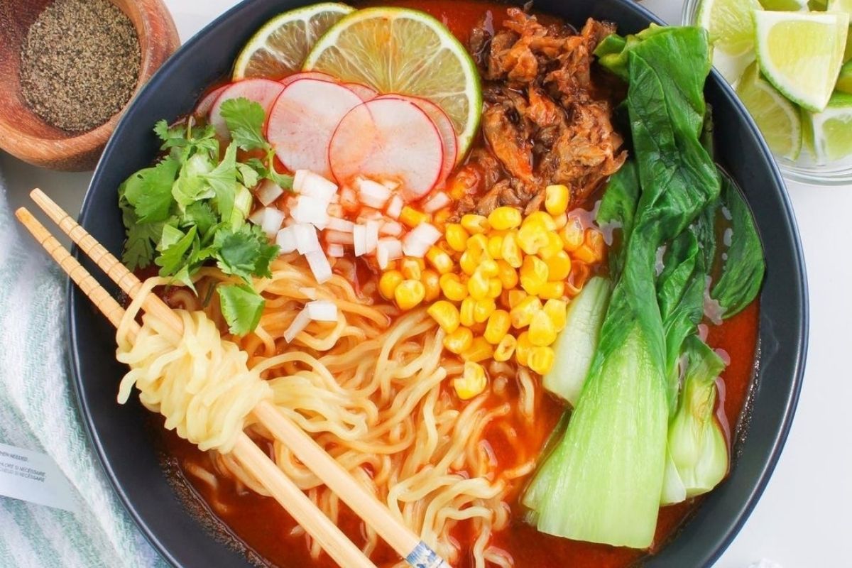 bowl of ramen topped with corn, radish, and more