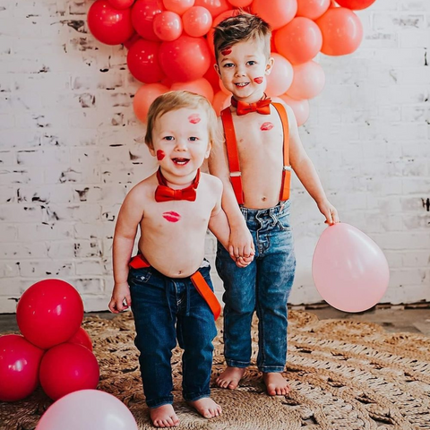 Little boys wearing red suspenders and red bowties for this valentine day.