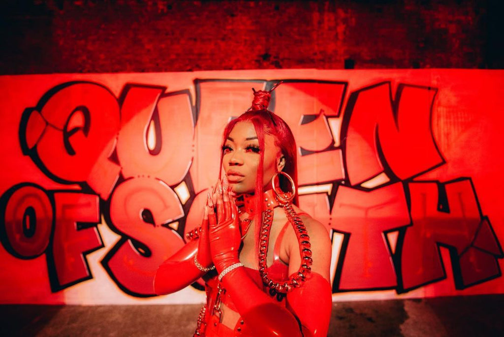 Shaybo Queen of the South wearing Jivomir Domoustchiev Red and Gold multi ring vegan vinyl harness for her Broke Boyz music video Out Now featuring Dream Doll