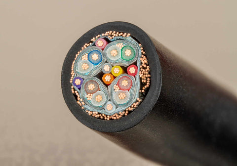 An image of a connection cable cut in half to show its internal circuitry.