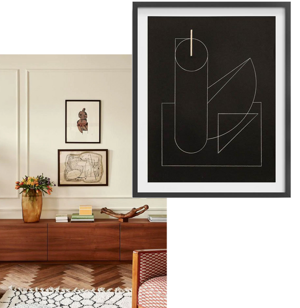 monochrome artworks styled above a mid-century cabinet