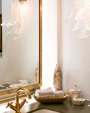 a sink with neatly organised towels and jewellery beside it