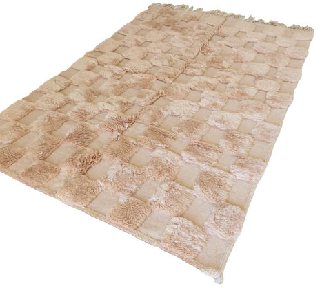 checkered blush rug with long and shaved wool pile