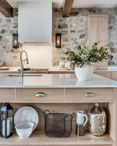 Kitchen with stone wall splash back, white oven hood and sconce boxes on either side