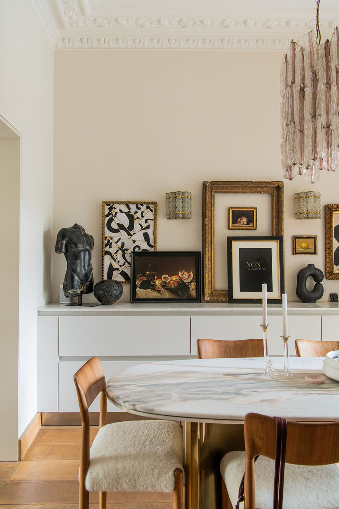 marble and brass dining table with shearling seats 