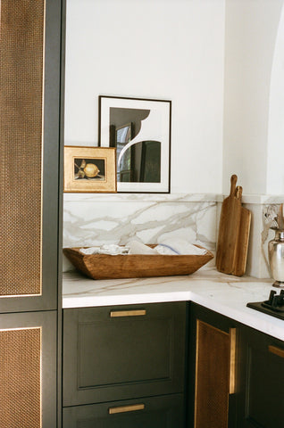 dark grey kitchen cabinets with brass mesh inserts
