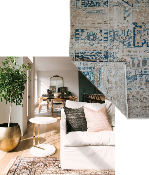 a close up of a living room designed by Jaclyn Peters. The corner of a white linen sofa and antique rug are visible, as is a gold plant pot and marble table with gold accents